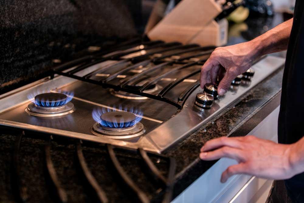 Gas hob burners lit after a gas stove installation in George