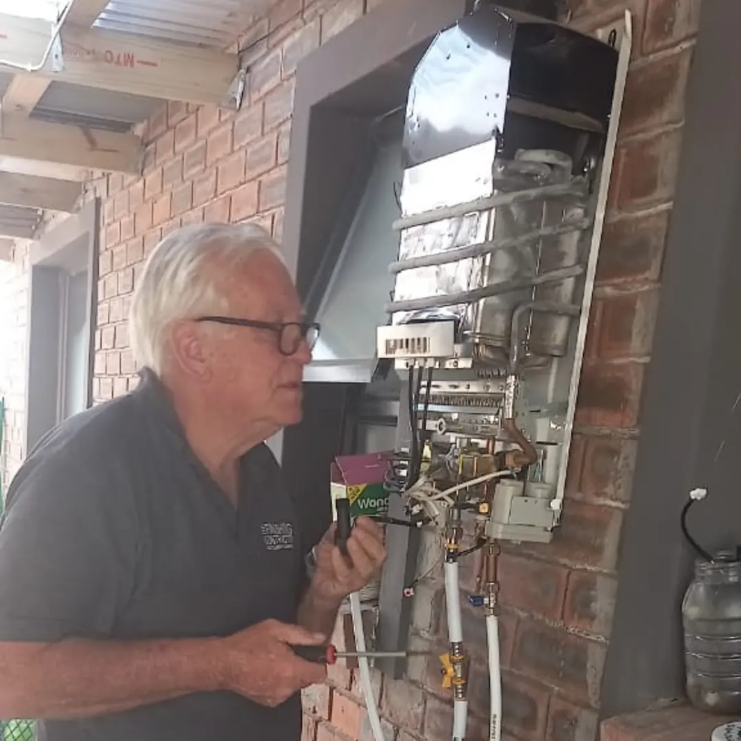 Alan Torley inspecting an opened gas geyser during a repair in George